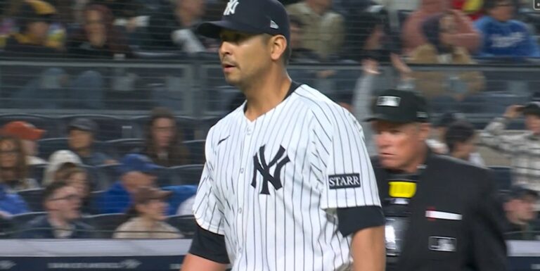Carlos Carrasco walks off the mound with a tie game
